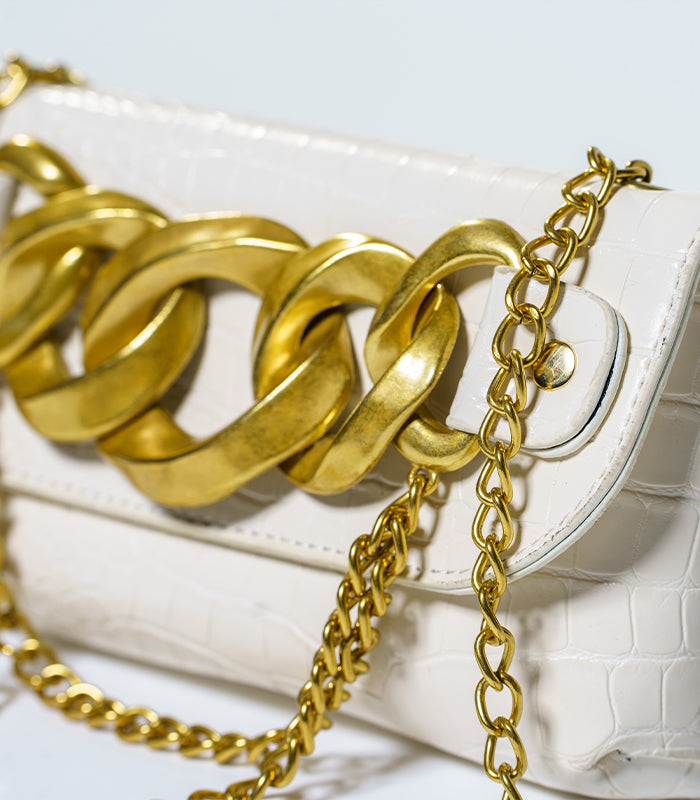 Close-up of Gianni mini bag showcasing the stylish full flap and elegant chain detailing